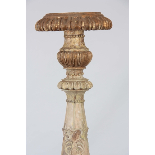 1243 - A LARGE PAIR OF CONTINENTAL CARVED PAINTED TORCHERES having acanthus leaf and gadrooned stems with c... 