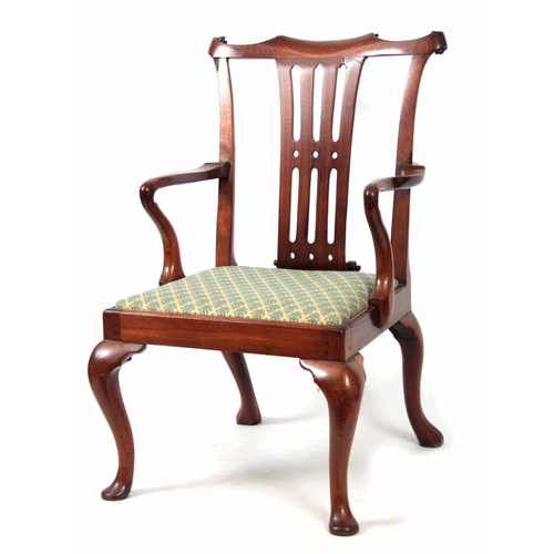 1245 - AN EARLY GEORGE III FIGURED MAHOGANY ARMCHAIR OF GENEROUS PROPORTIONS with shaped top rail and scrol... 