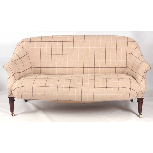 1258 - A VICTORIAN MAHOGANY TWO-SEATER SETTEE standing on ring turned legs with under castors 159cm wide.