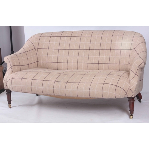 1258 - A VICTORIAN MAHOGANY TWO-SEATER SETTEE standing on ring turned legs with under castors 159cm wide.