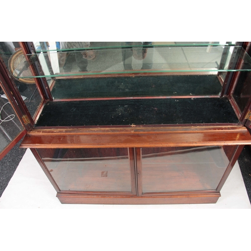 1263 - A 19TH CENTURY MAHOGANY SHOP KEEPERS DISPLAY CABINET with hinged glazed doors enclosing a fitted mir... 