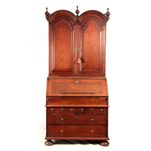 1267 - A WILLIAM AND MARY WALNUT BUREAU BOOKCASE the double-domed top with fielded panelled doors revealing... 