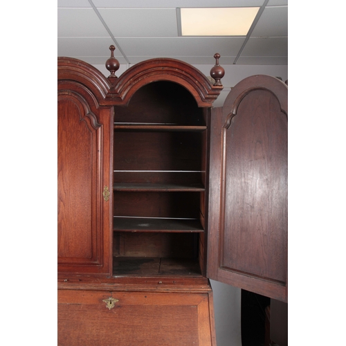 1267 - A WILLIAM AND MARY WALNUT BUREAU BOOKCASE the double-domed top with fielded panelled doors revealing... 