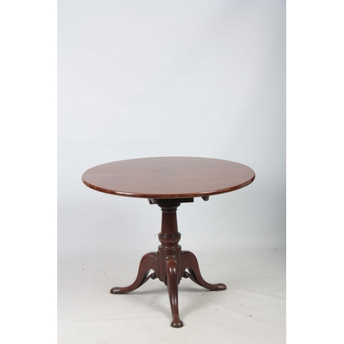 1269 - A GEORGE III MAHOGANY TILT TOP TABLE with a one-piece circular top, standing on gun barrel turned st... 