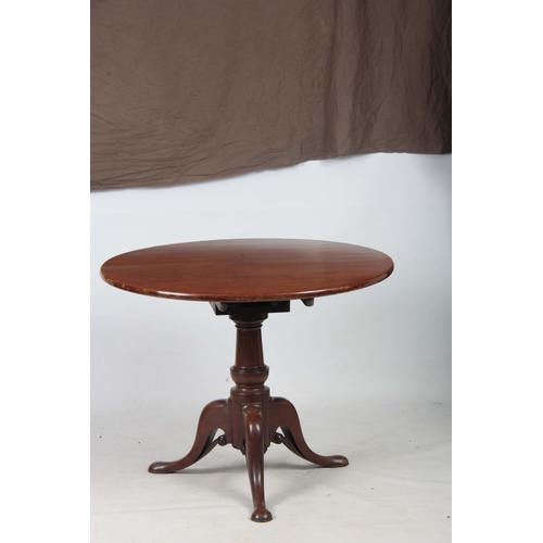 1269 - A GEORGE III MAHOGANY TILT TOP TABLE with a one-piece circular top, standing on gun barrel turned st... 