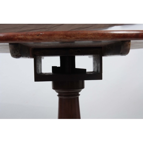 1269 - A GEORGE III MAHOGANY TILT TOP TABLE with a one-piece circular top, standing on gun barrel turned st... 