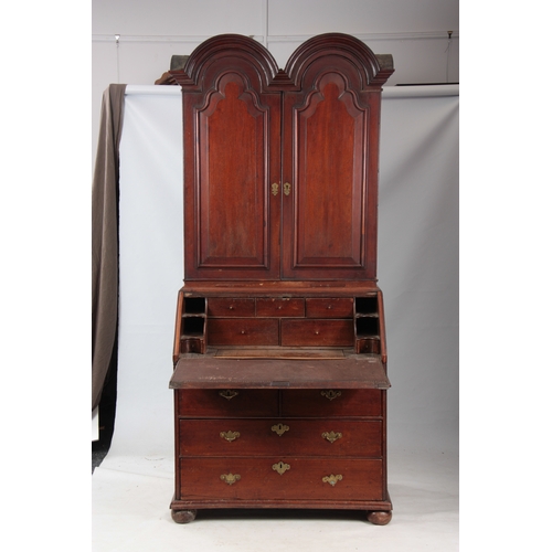 1272 - A WILLIAM AND MARY WALNUT BUREAU BOOKCASE the double-domed top with fielded panelled doors revealing... 