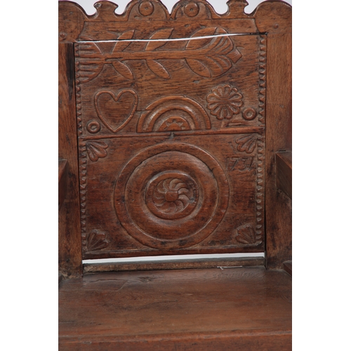 1281 - AN 18TH CENTURY OAK WAINSCOT CHAIR OF SMALL PROPORTIONS having carved back, dated 1731 with open arm... 