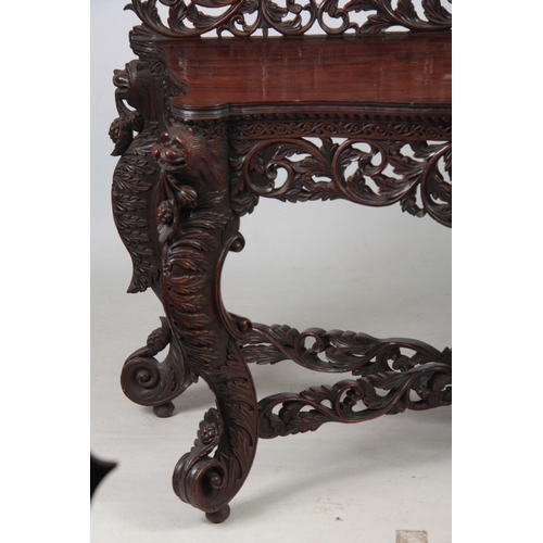 1282 - A PAIR OF 19TH CENTURY ANGLO-INDIAN CARVED ROSEWOOD CONSOLE TABLES having pierced foliate ledge back... 