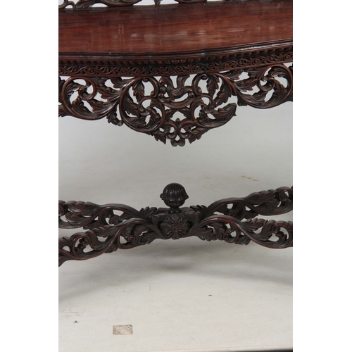 1282 - A PAIR OF 19TH CENTURY ANGLO-INDIAN CARVED ROSEWOOD CONSOLE TABLES having pierced foliate ledge back... 