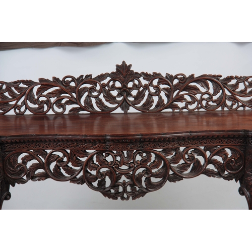 1282 - A PAIR OF 19TH CENTURY ANGLO-INDIAN CARVED ROSEWOOD CONSOLE TABLES having pierced foliate ledge back... 