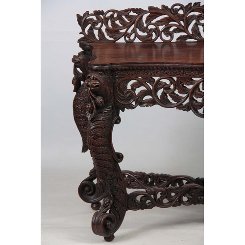 1282 - A PAIR OF 19TH CENTURY ANGLO-INDIAN CARVED ROSEWOOD CONSOLE TABLES having pierced foliate ledge back... 