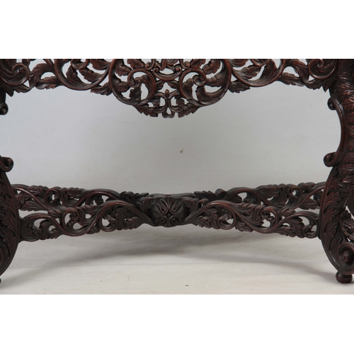 1282 - A PAIR OF 19TH CENTURY ANGLO-INDIAN CARVED ROSEWOOD CONSOLE TABLES having pierced foliate ledge back... 