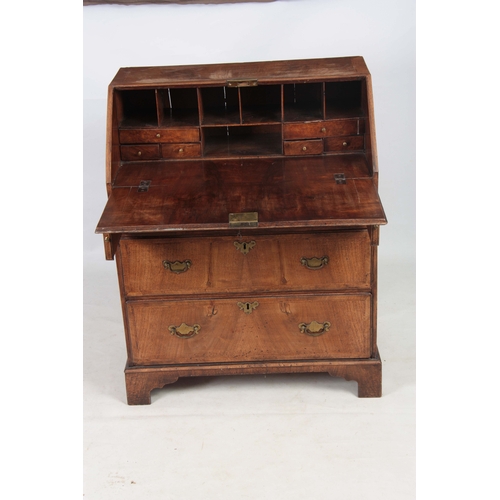 1283 - A SMALL EARLY 18TH CENTURY WALNUT BUREAU having an angled hinged fall revealing an interior of small... 