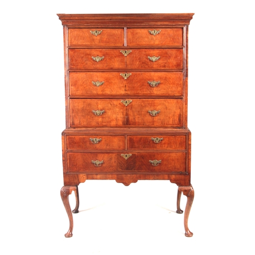 1284 - AN EARLY 18TH CENTURY FIGURED WALNUT CHEST ON STAND with moulded cornice above a drawer configuratio... 