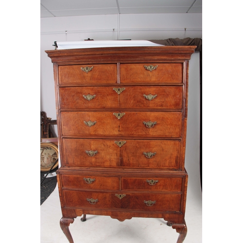 1284 - AN EARLY 18TH CENTURY FIGURED WALNUT CHEST ON STAND with moulded cornice above a drawer configuratio... 