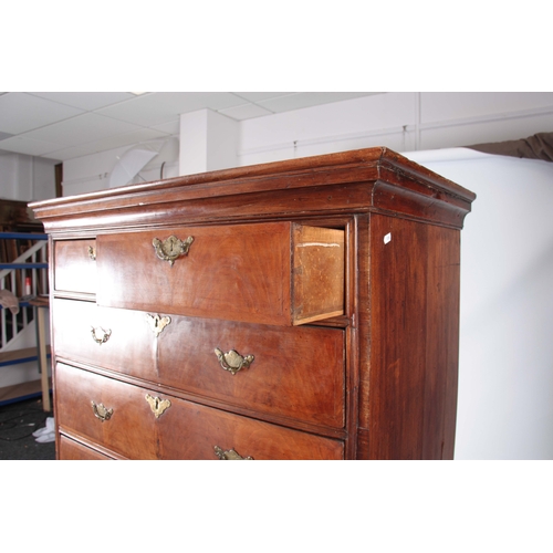 1284 - AN EARLY 18TH CENTURY FIGURED WALNUT CHEST ON STAND with moulded cornice above a drawer configuratio... 