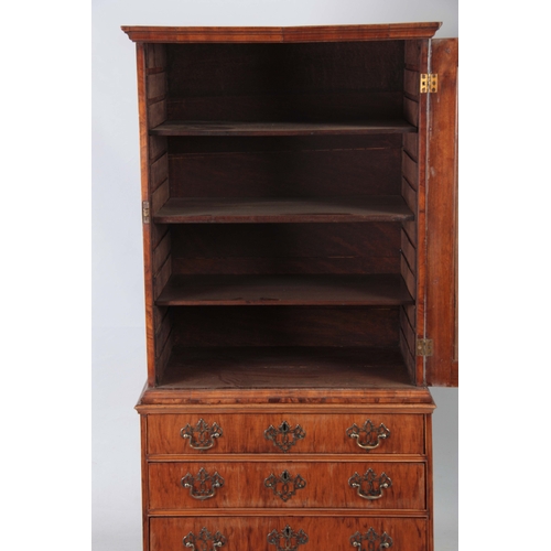 1285 - AN EARLY 18TH CENTURY FIGURED WALNUT MIRRORED CABINET ON CHEST with hinged door revealing a shelved ... 