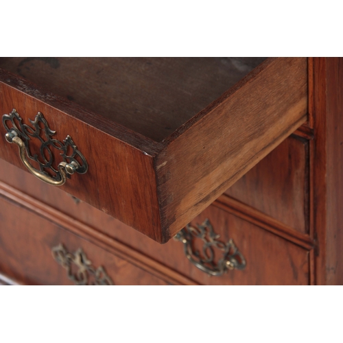 1285 - AN EARLY 18TH CENTURY FIGURED WALNUT MIRRORED CABINET ON CHEST with hinged door revealing a shelved ... 