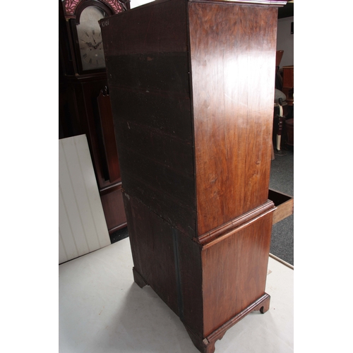 1285 - AN EARLY 18TH CENTURY FIGURED WALNUT MIRRORED CABINET ON CHEST with hinged door revealing a shelved ... 