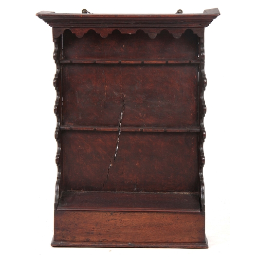 1288 - AN 18TH CENTURY OAK AND FRUITWOOD HANGING SPOON RACK with moulded cornice above wavey edge shaped si... 