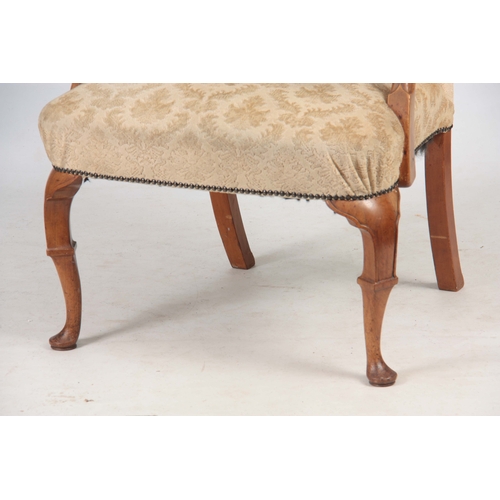 1291 - A GEORGE I STYLE WALNUT UPHOLSTERED ARM CHAIR with arched shaped back above sweeping scrolled arms; ... 