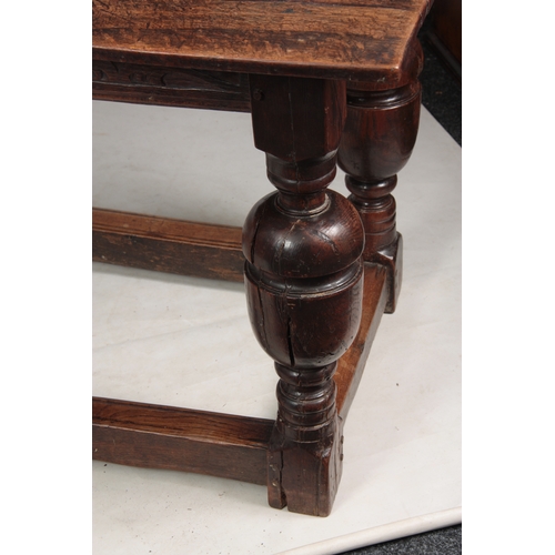 1295 - AN EARLY 18TH CENTURY OAK REFECTORY TABLE with plank top above a carved blind fret frieze; standing ... 