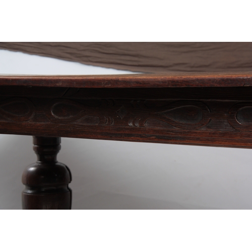 1295 - AN EARLY 18TH CENTURY OAK REFECTORY TABLE with plank top above a carved blind fret frieze; standing ... 