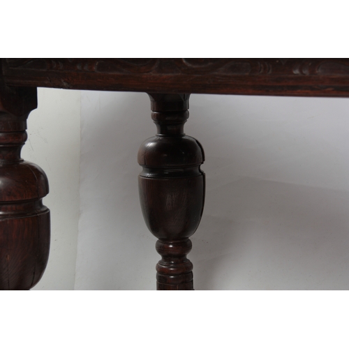 1295 - AN EARLY 18TH CENTURY OAK REFECTORY TABLE with plank top above a carved blind fret frieze; standing ... 