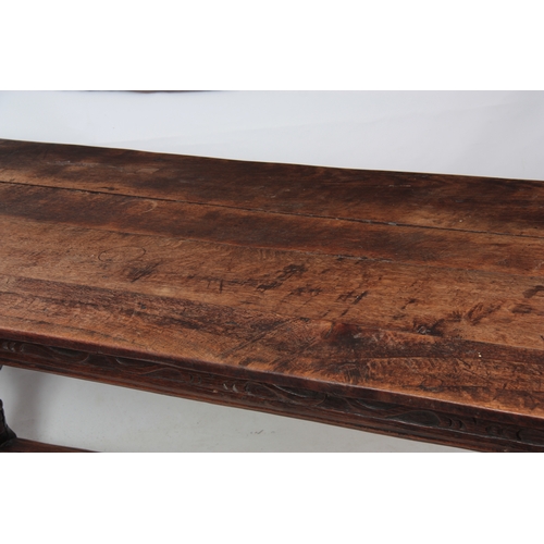 1295 - AN EARLY 18TH CENTURY OAK REFECTORY TABLE with plank top above a carved blind fret frieze; standing ... 