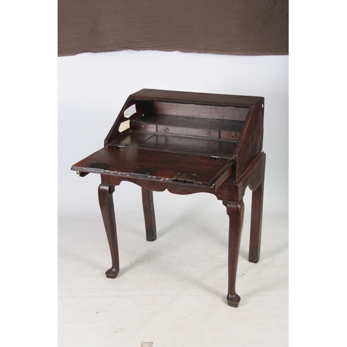 1297 - AN 18TH CENTURY OAK BUREAU ON STAND with hinged angled fall fitted with three iron locks having bras... 