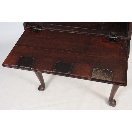 1297 - AN 18TH CENTURY OAK BUREAU ON STAND with hinged angled fall fitted with three iron locks having bras... 