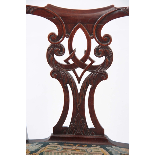 1300 - A GEORGE III CHIPPENDALE STYLE MAHOGANY OPEN ARMCHAIR with scrolled, leaf carved, pierced back splat... 