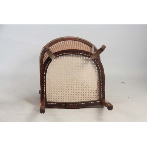 1303 - A LATE 19TH CENTURY ADAM STYLE BERGERE CHAIR with arcaded shaped back and rams head arms above leaf ... 