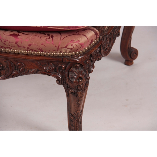 1312 - A FINE PAIR OF 18TH CENTURY FRENCH ROCOCO CARVED WALNUT OPEN ARMCHAIRS  with upholstered shaped back... 