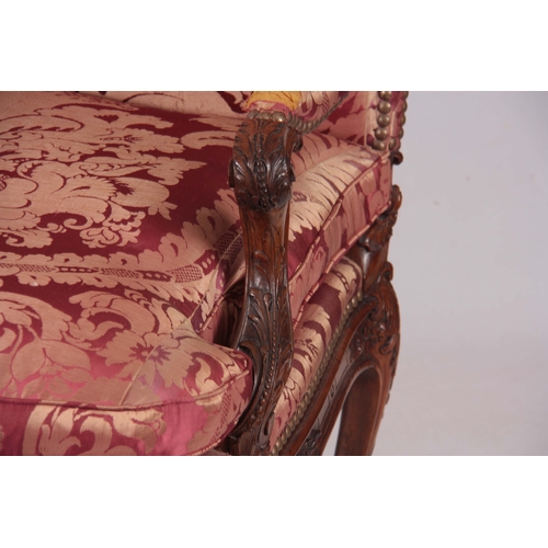 1312 - A FINE PAIR OF 18TH CENTURY FRENCH ROCOCO CARVED WALNUT OPEN ARMCHAIRS  with upholstered shaped back... 