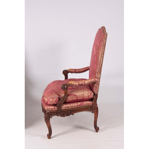 1312 - A FINE PAIR OF 18TH CENTURY FRENCH ROCOCO CARVED WALNUT OPEN ARMCHAIRS  with upholstered shaped back... 