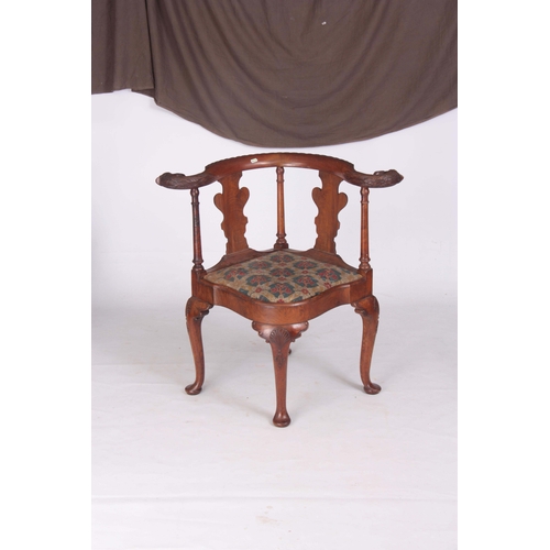 1313 - A 19TH CENTURY GEORGE I STYLE WALNUT CORNER CHAIR with carved eagles head top rail above solid shape... 