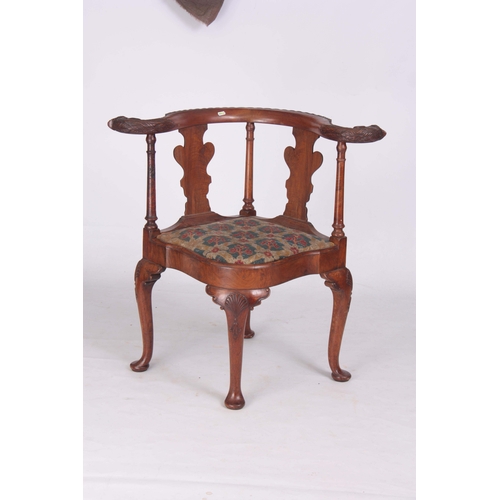 1313 - A 19TH CENTURY GEORGE I STYLE WALNUT CORNER CHAIR with carved eagles head top rail above solid shape... 