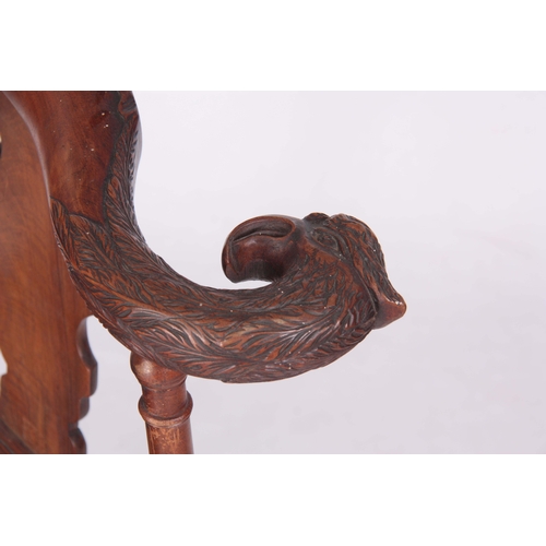 1313 - A 19TH CENTURY GEORGE I STYLE WALNUT CORNER CHAIR with carved eagles head top rail above solid shape... 