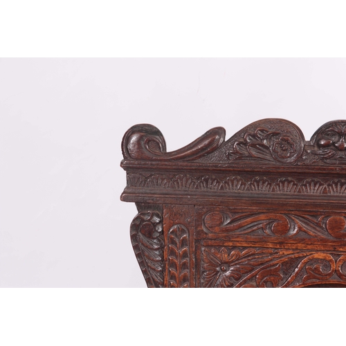 1317 - A 17TH CENTURY AND LATER OAK WAINSCOT CHAIR with eared shaped carved top rail centred  by an arched ... 