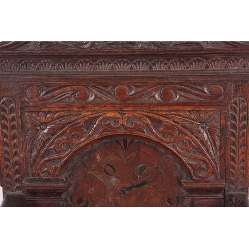 1317 - A 17TH CENTURY AND LATER OAK WAINSCOT CHAIR with eared shaped carved top rail centred  by an arched ... 