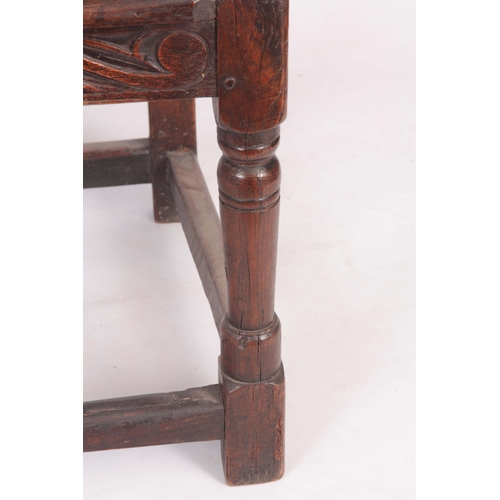 1317 - A 17TH CENTURY AND LATER OAK WAINSCOT CHAIR with eared shaped carved top rail centred  by an arched ... 