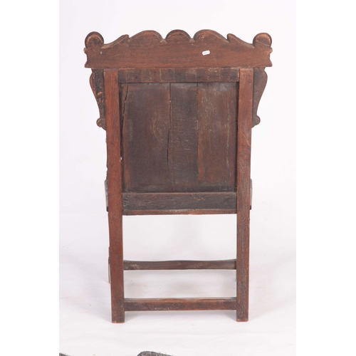 1317 - A 17TH CENTURY AND LATER OAK WAINSCOT CHAIR with eared shaped carved top rail centred  by an arched ... 