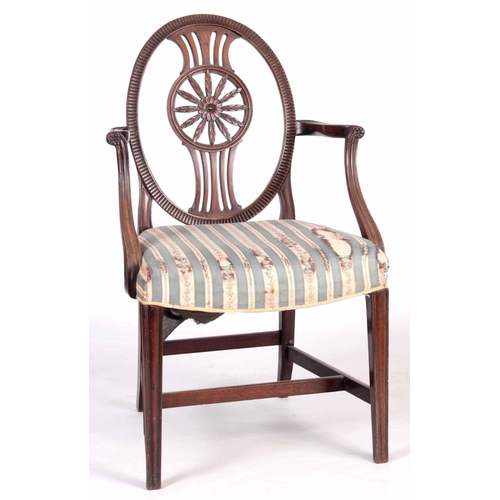 1318 - A 19TH CENTURY SHERATON STYLE OPEN ARMCHAIR with oval back having a carved floral centre, swept open... 