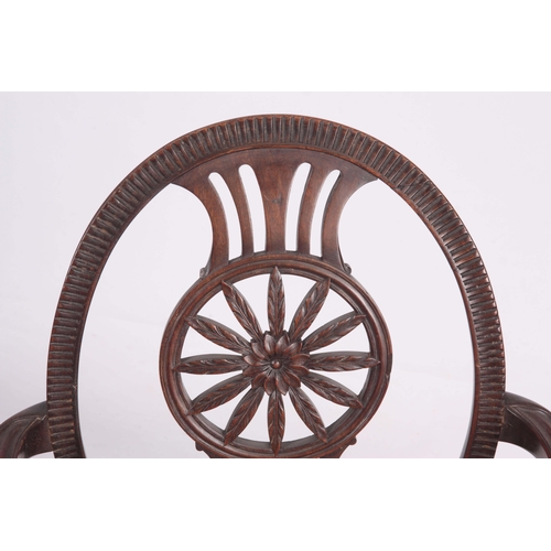 1318 - A 19TH CENTURY SHERATON STYLE OPEN ARMCHAIR with oval back having a carved floral centre, swept open... 