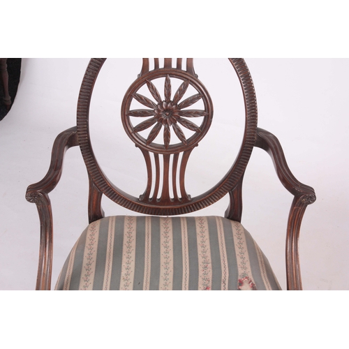 1318 - A 19TH CENTURY SHERATON STYLE OPEN ARMCHAIR with oval back having a carved floral centre, swept open... 