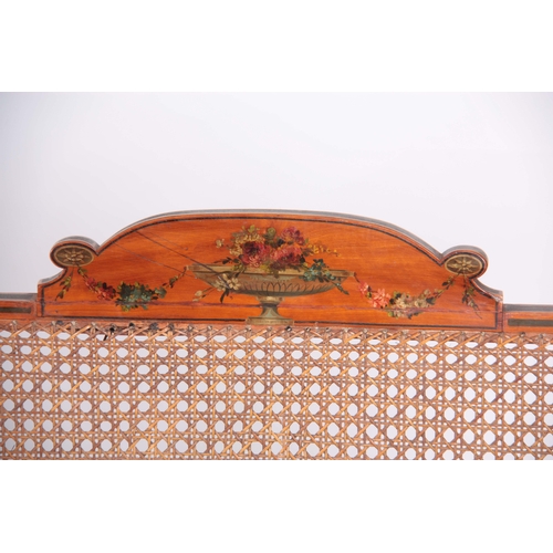 1320 - A 19TH CENTURY ADAM STYLE PAINTED SATINWOOD BERGERE THREE SEATER SETTEE with painted floral urns - b... 