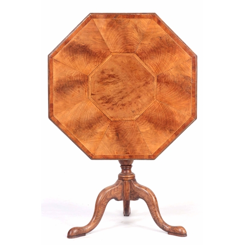 1325 - A GEORGE III OCTAGONAL SHAPED TILT TOP TABLE with figured and burr Elm segmented top; standing on an... 