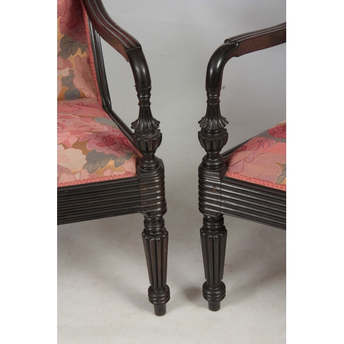 1328 - A PAIR OF 19TH CENTURY SOLID EBONY ANGLO INDIAN ARMCHAIRS with reeded shell carved back joined by sh... 